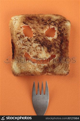 Happy toast and fork on a cutting board