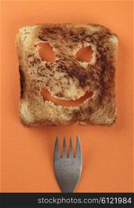 Happy toast and fork on a cutting board