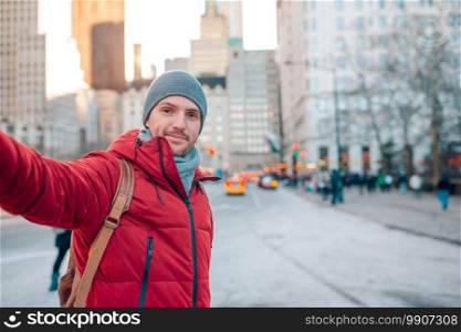 Happy tourist man taking selfie in New York City on the streets. Young man have fun in Central Park at New York City