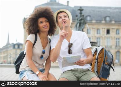 happy tourists with map sightseeing city