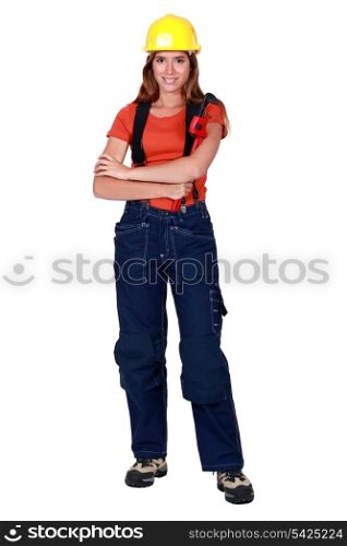 Happy tradeswoman holding a pipe wrench