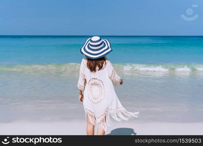Happy traveler Asian woman enjoys at tropical beach on vacation. Summer on beach concept.