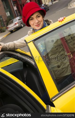 Happy Traveler Female Locates and Enters Taxi Cab Downtown