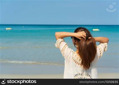 Happy traveller Asian woman enjoy at tropical beach on vacation. Summer on beach concept.