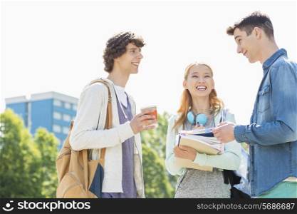 Happy university students conversing at campus