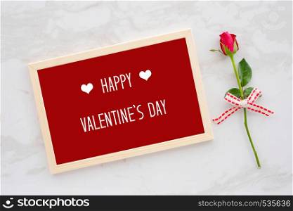 Happy valentine?s day card in wooden frame and red rose on white marble background, banner, flat lay