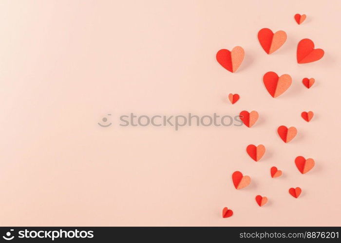 Happy Valentine’s day concept. Red paper hearts cutting pastel pink background, Symbol of love paper art with copy space for text, Mother’s Day