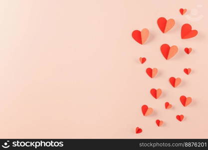 Happy Valentine’s day concept. Red paper hearts cutting pastel pink background, Symbol of love paper art with copy space for text, Mother’s Day