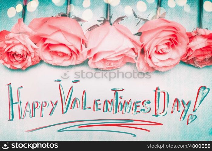 Happy Valentines Day greeting, handwritten, with pink roses and bokeh on blue backgound.