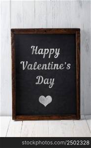 Happy Valentines Day text on vintage blank chalkboard