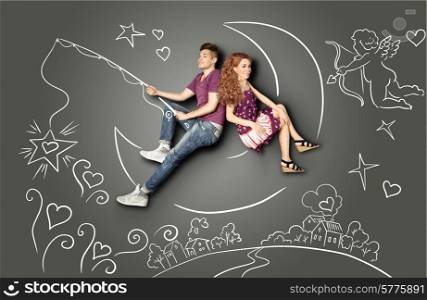 Happy valentines love story concept of a romantic couple fishing on a moon with a star on a hook against chalk drawings background of a night sky and a Cupid.