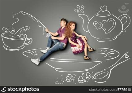 Happy valentines love story concept of a romantic couple sitting on a saucer and fishing in a teacup against chalk drawings background.