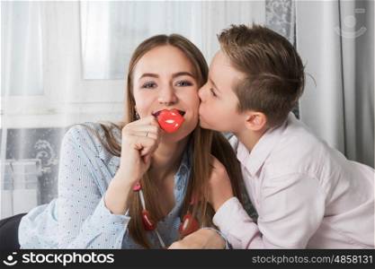 Happy Valentines or mother day. Happy Valentines Day or Mother day. Young boy and mum celebrate with gingerbread heart cookies on a stick.