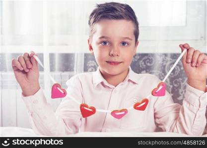 Happy Valentines or mother day. Young boy with gingerbread heart cookies. To Illustrate the Happy Valentines Day or Mother day.