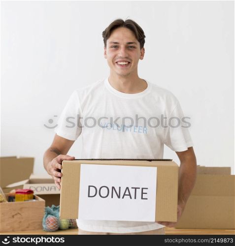 happy volunteer holding donate box
