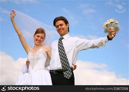 happy wedding couple on sky