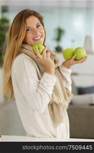 happy woman biting a green apple