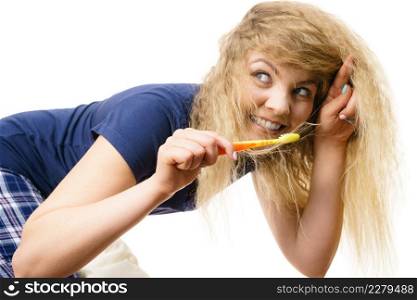 Happy woman brushing her teeth. Having fun during morning routine concept. Isolated background.. Happy woman brushing her teeth