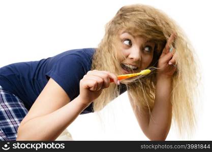 Happy woman brushing her teeth. Having fun during morning routine concept. Isolated background.. Happy woman brushing her teeth