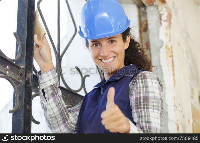 happy woman builder shows thumbs up