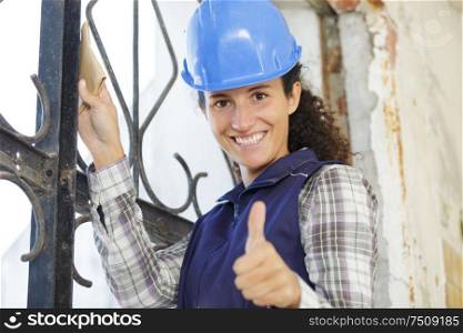 happy woman builder shows thumbs up