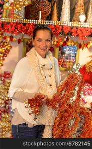 Happy woman buyer shopping Christmas tinsel decoration