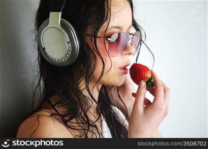 happy woman dance in phones and eat strawberry
