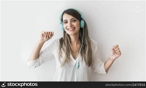 happy woman dancing with earphones
