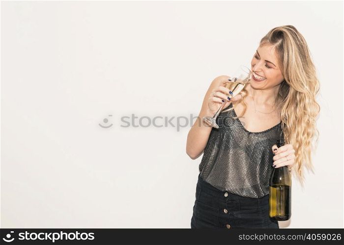 happy woman drinking champagne from glass