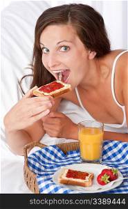 Happy woman eating toast, homemade breakfast
