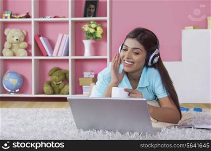 Happy woman enjoying music at home