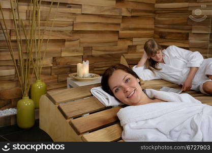 Happy woman enjoying wellness treatment at spa center