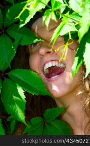 happy woman face in foliage