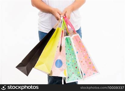 Happy woman hand holding shopping bags multicolor, young female hold many packets within arms isolated on white background, Black friday sale concept