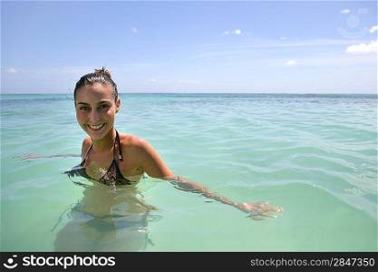 Happy woman having a bath in the sea