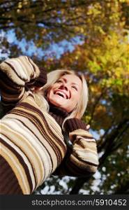 Happy woman having fun in autumn park. Happy autumn woman