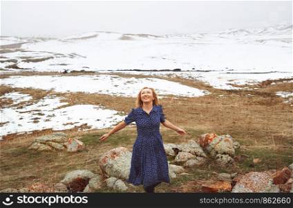 Happy woman having fun in the winter landscape