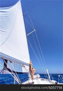 Happy woman having fun on sailboat, enjoying active summer vacation, luxury water transport, relaxation and enjoyment concept