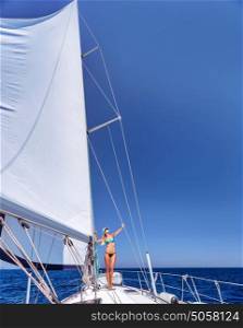 Happy woman having fun on sailboat, enjoying active summer vacation, luxury water transport, relaxation and enjoyment concept
