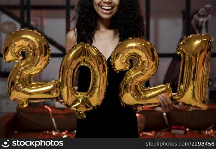 happy woman holding 2021 balloons party
