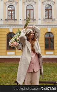 happy woman holding bouquet flowers outdoors spring