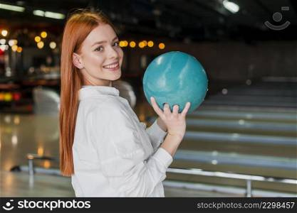 happy woman holding bowling ball