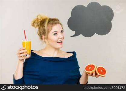 Happy woman holding fresh orange grapefruit juice. Healthy fruit drink smoothies concept, black thinking or speech bubble next to her.. Happy woman holding fresh orange juice