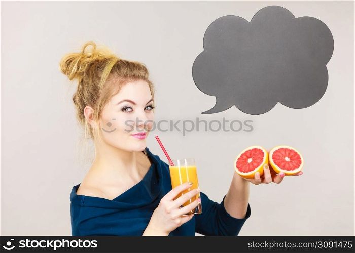 Happy woman holding fresh orange grapefruit juice. Healthy fruit drink smoothies concept, black thinking or speech bubble next to her.. Happy woman holding fresh orange juice