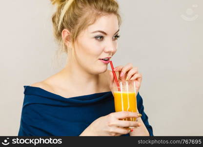 Happy woman holding fresh orange grapefruit juice. Healthy fruit drink smoothies concept.. Happy woman holding fresh orange juice