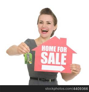 Happy woman holding home for sale sign and keys. HQ photo. Not oversharpened. Not oversaturated. Happy woman holding home for sale sign and keys isolated