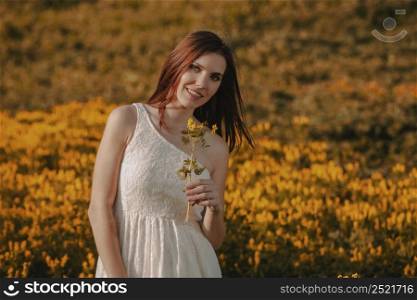 Happy woman holding wild flowers