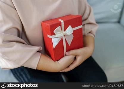 Happy woman hugging gift box. Receiving Valentine present. Cheerful girl with Xmas present or open box xmas new year birthday gift.