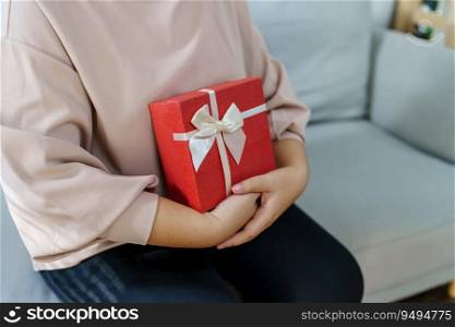 Happy woman hugging gift box. Receiving Valentine present. Cheerful girl with Xmas present or open box xmas new year birthday gift.