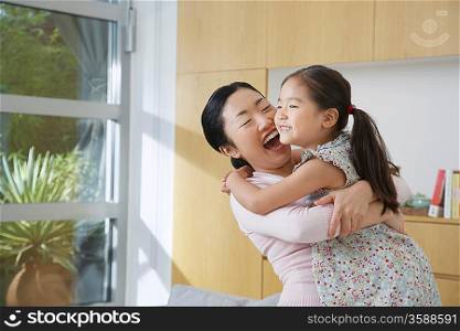 Happy Woman Hugging her Daughter